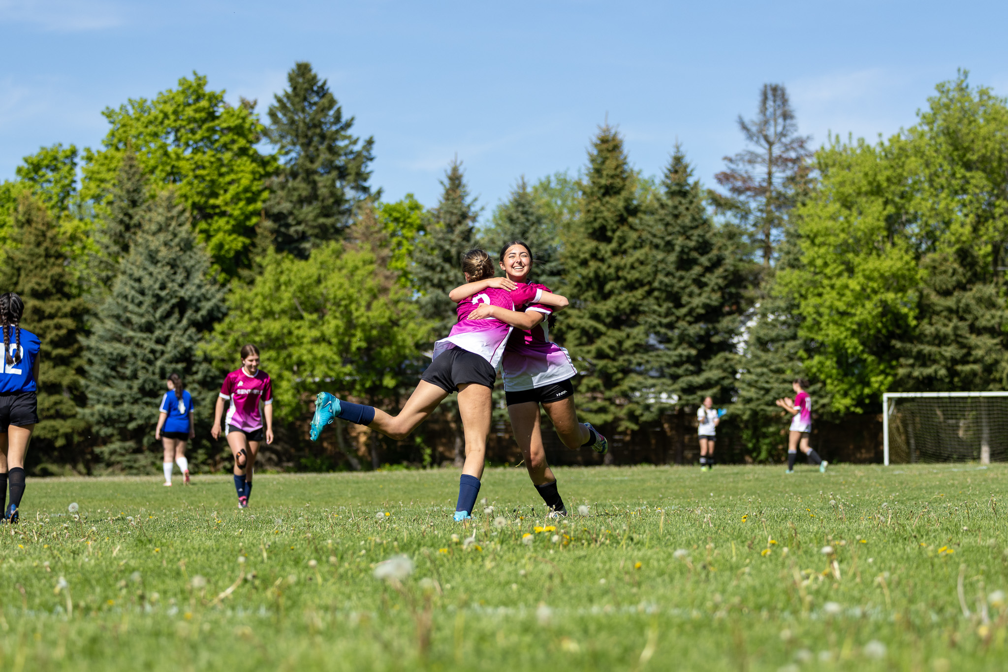 Basketball players lined up courtside in blue jerseys before tip-off in the GTA
