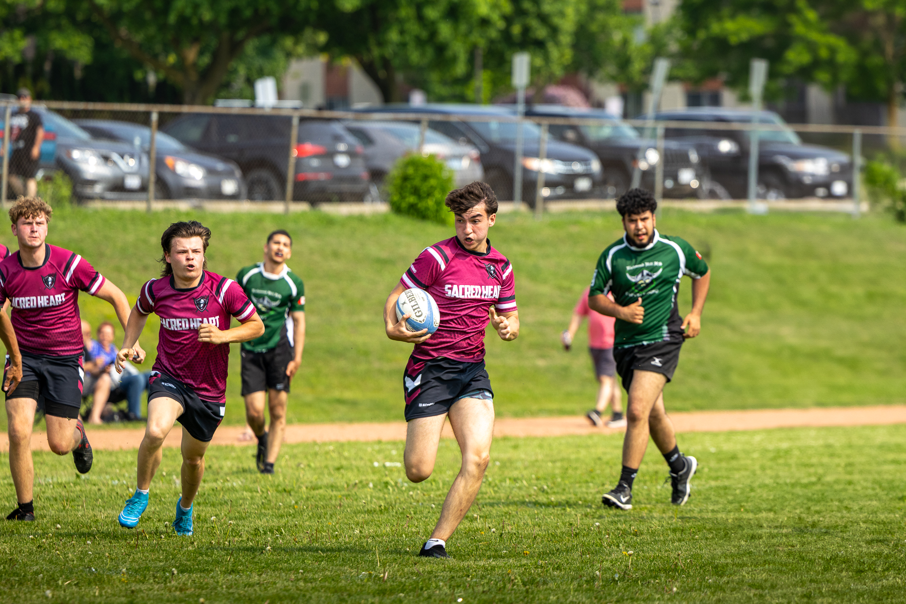 Two soccer players battling for the ball on an outdoor turf field in the GTA