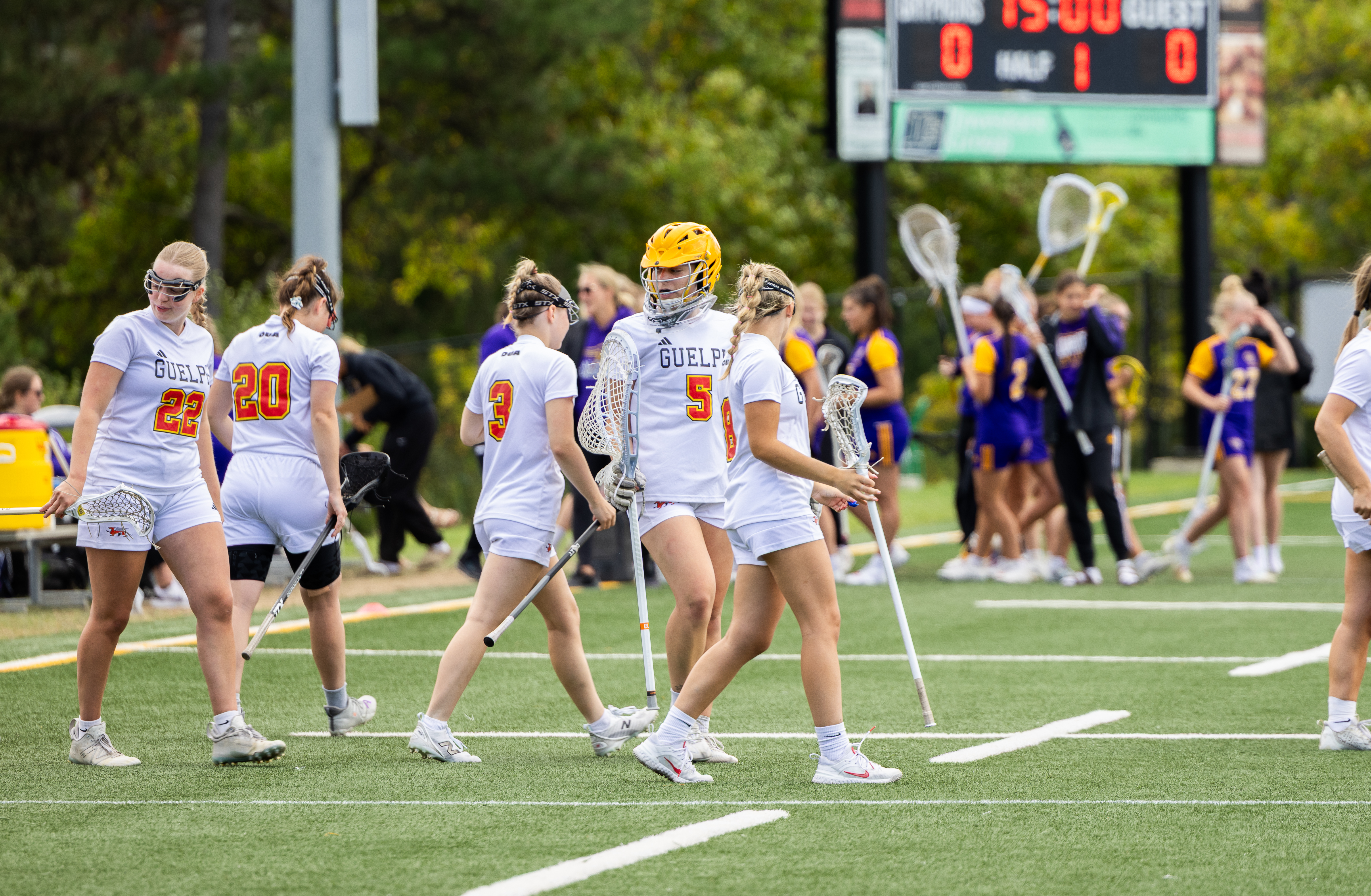 Basketball team huddled courtside during a competitive GTA league game